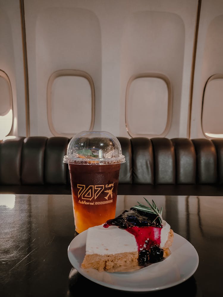 A Slice Of Cake And Ice Tea In A Cup 