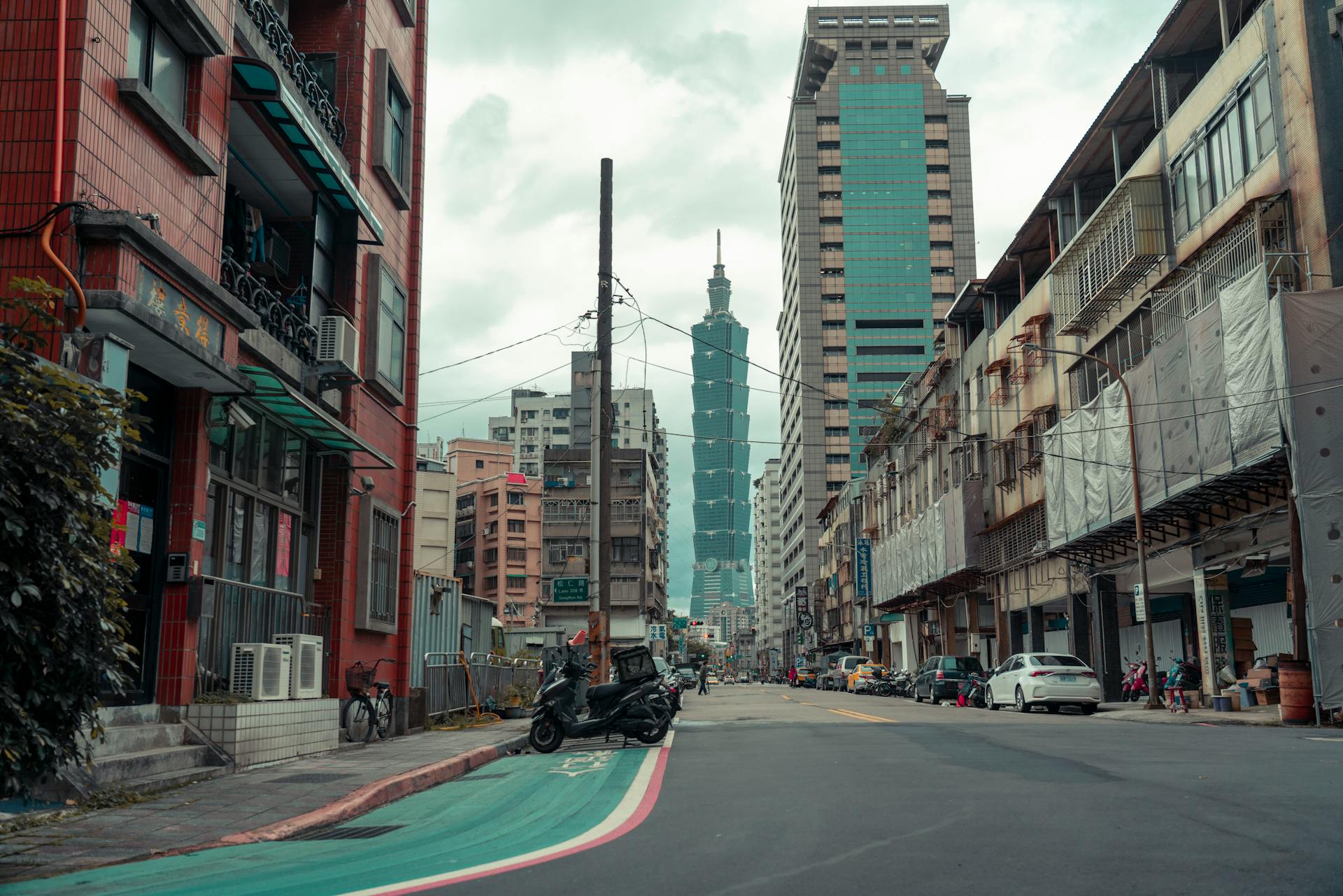 Cars on Road Between High Rise Buildings