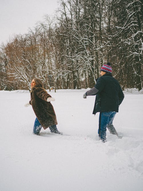 A Man and Woman Standing on the Snow 