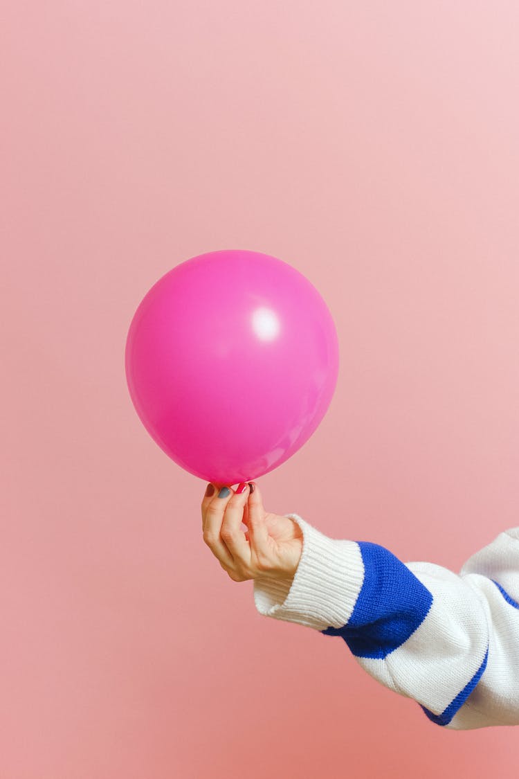 Close-up Of Holding A Pink Balloon