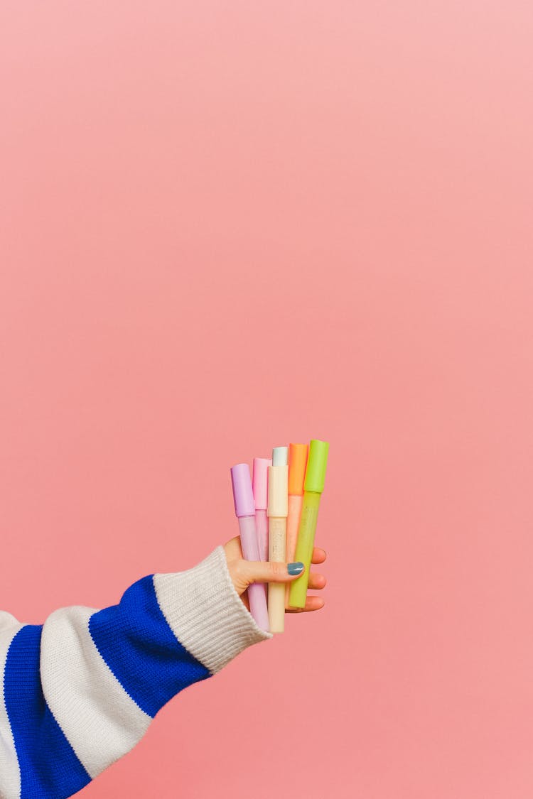 A Person Holding Colored Markers