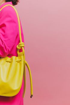 Vibrant image of a yellow bag with a pink background, perfect for fashion and color contrast themes.