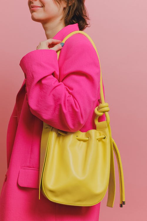 A Woman in Pink Blazer and with Yellow Hand Bag