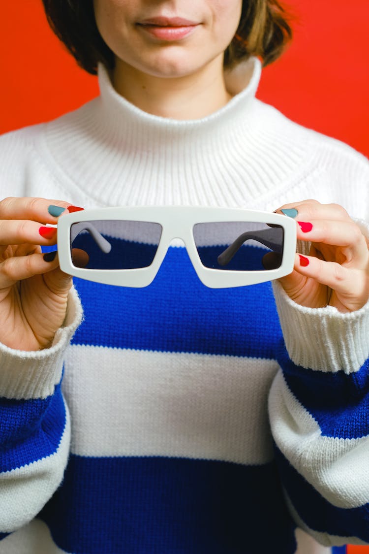 Person Holding White Framed Sunglasses