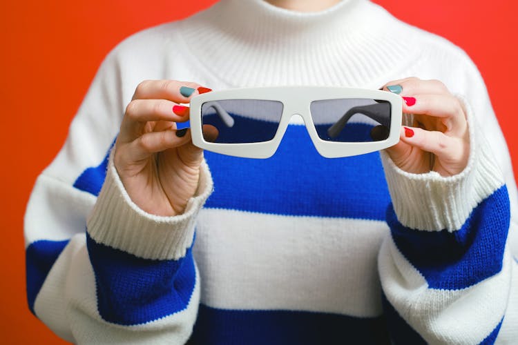 Person Holding White Framed Sunglasses