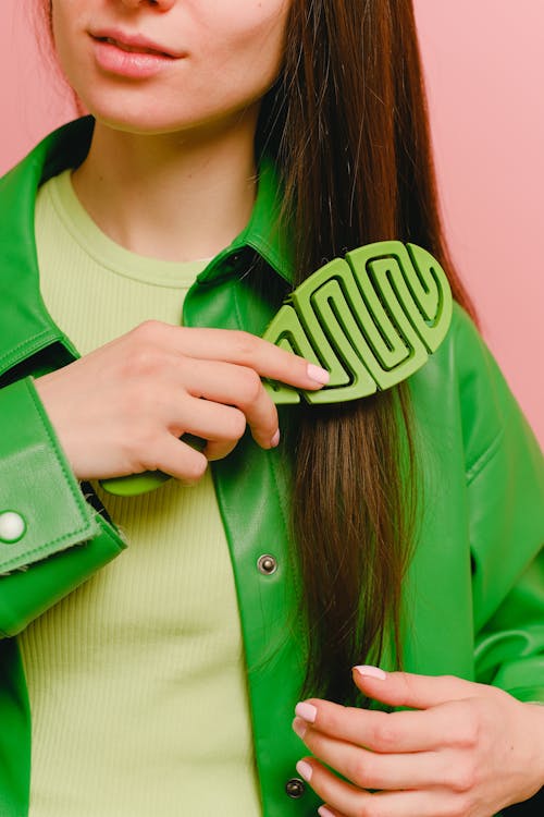 Woman using straightener for sleek hair. Tips: clean, dry hair; heat protectant spray; divide into sections; high-quality straightener; work in small sections; avoid excessive heat; finish with serum. Follow instructions, consult professional if needed