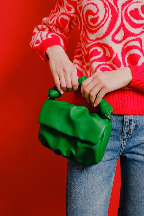 A Person in Red Sweater Holding Green Handbag