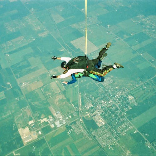 Free Skydiving in Tandem above Urban Area Stock Photo