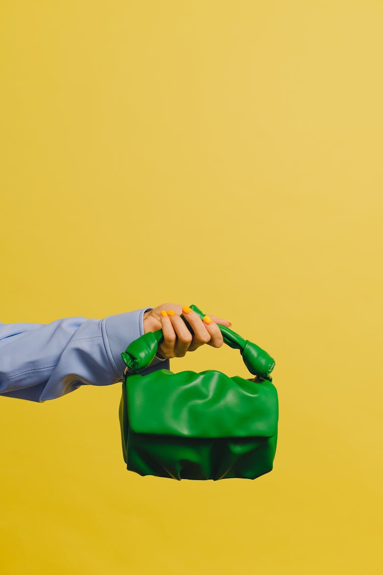 A Person Holding A Green Handbag