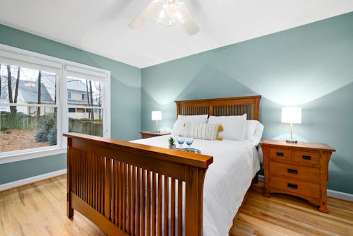 Brown Wooden Bed Near Glass Windows