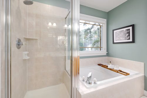 White Ceramic Bathtub Near Shower Screen
