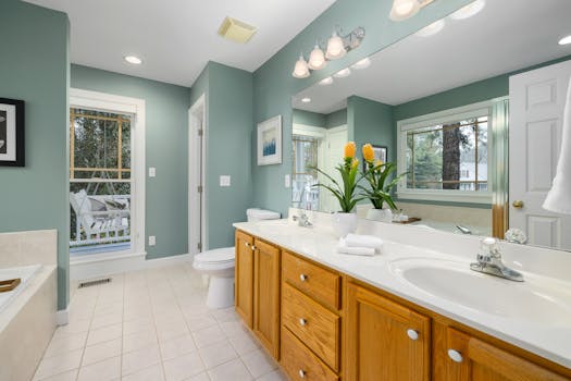 Spacious bathroom featuring a dual sink vanity, large mirrors, and elegant interior design.