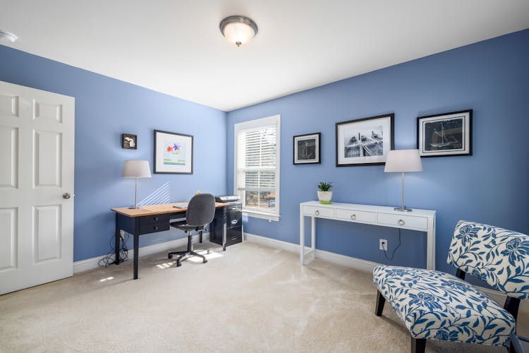 Indoor View Of Office Room With Desk And Laptop At Home