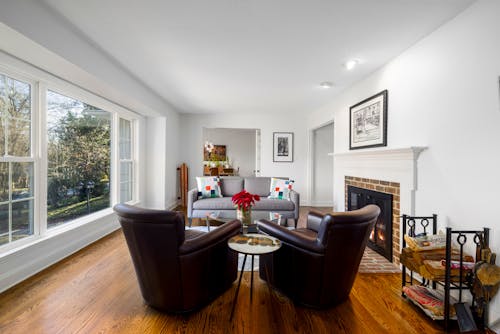 Couch and Armchairs and Side Table Near a Fireplace