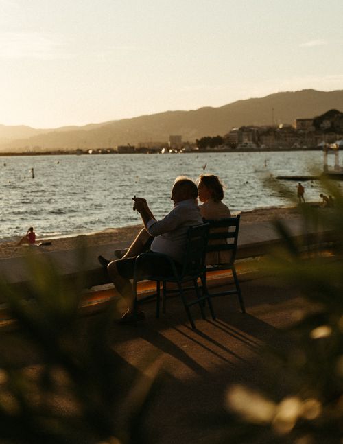 Free A couple enjoying a sunset on Cannes beach, capturing the romance and tranquility of the moment. Stock Photo