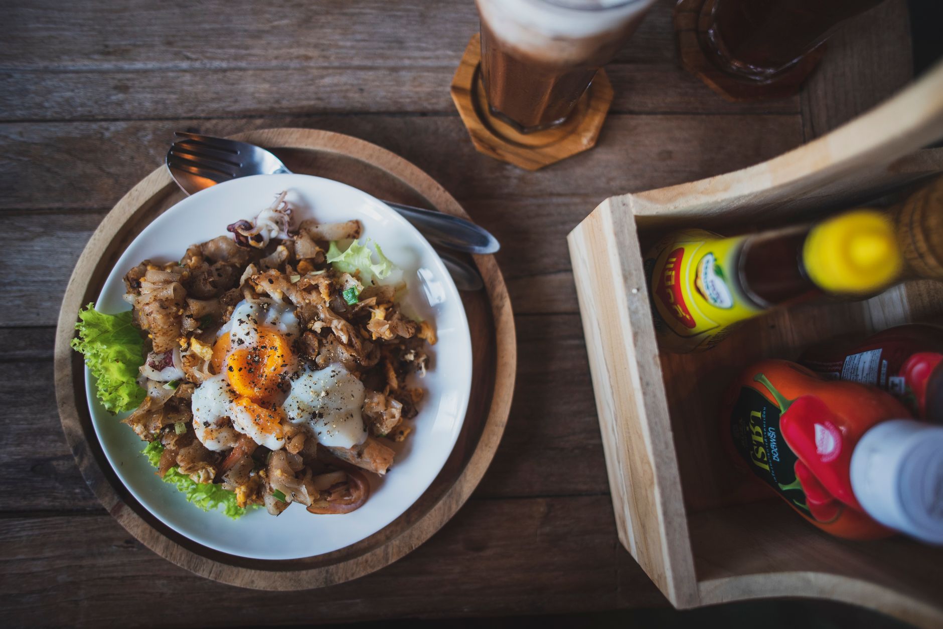 10 Quick Keto Meal Recipes For Busy Weeknights 1 Top view of a delicious meal featuring a poached egg, lettuce, and condiments on a rustic table.