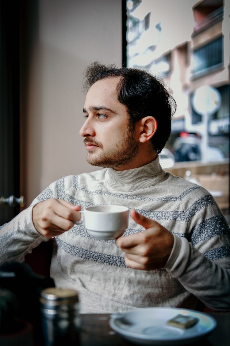 Man Sitting In A Cafe 