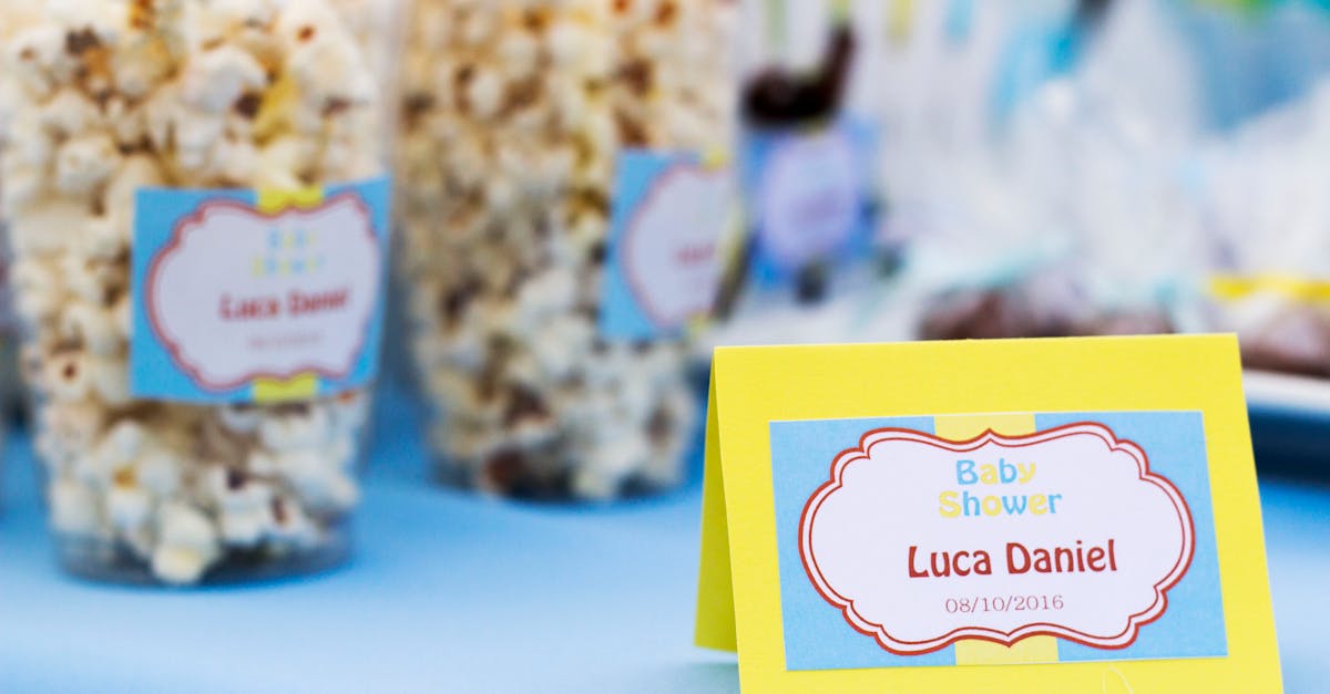 Popcorn treats with colorful labels at a baby shower celebration table.