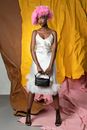 Female Model Posing in White Dress and Pink Toupee