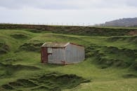 Brown Wooden House on Green Grass Field