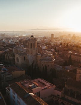 Stunning aerial view of Tarragona, Spain during sunset showcasing urban cityscape and Mediterranean architecture.