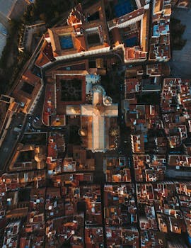 Stunning aerial view of Tarragona cityscape during sunrise, showcasing vibrant urban architecture.
