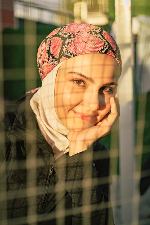 Portrait of Smiling Woman in Hat and Hijab 