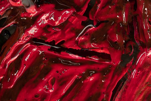 Dynamic red and black abstract texture with glossy finish, ideal for backgrounds.