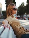 Woman in Brown Long Sleeve Shirt Wearing Black Sunglasses