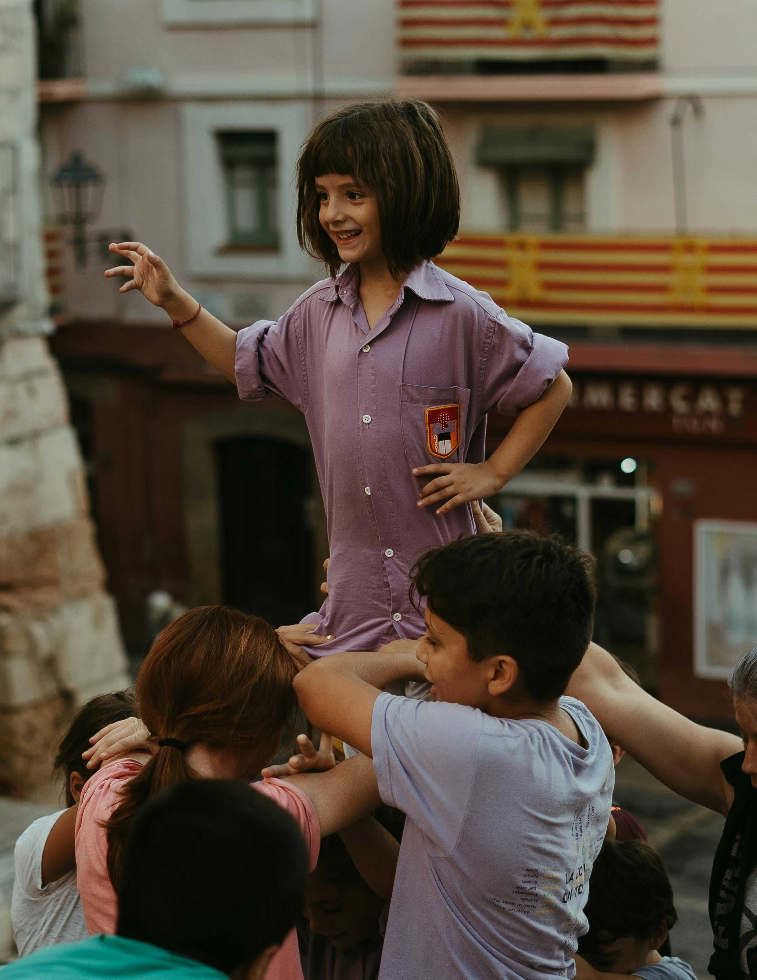 photo of a girl being lifted by children