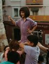 Girl in Pink Polo Shirt Standing in Front of Children