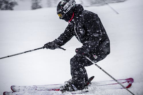 Free A Person in Black Ski Suit Skiing in Snow Stock Photo