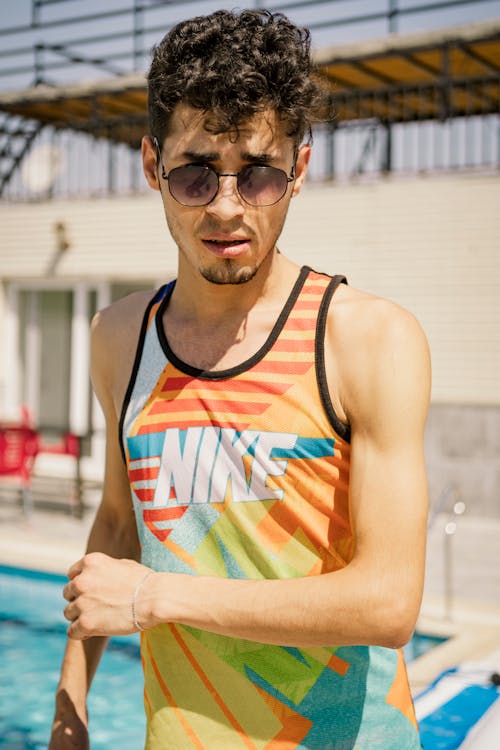 Photograph of a Man in a Tank Top Wearing Sunglasses