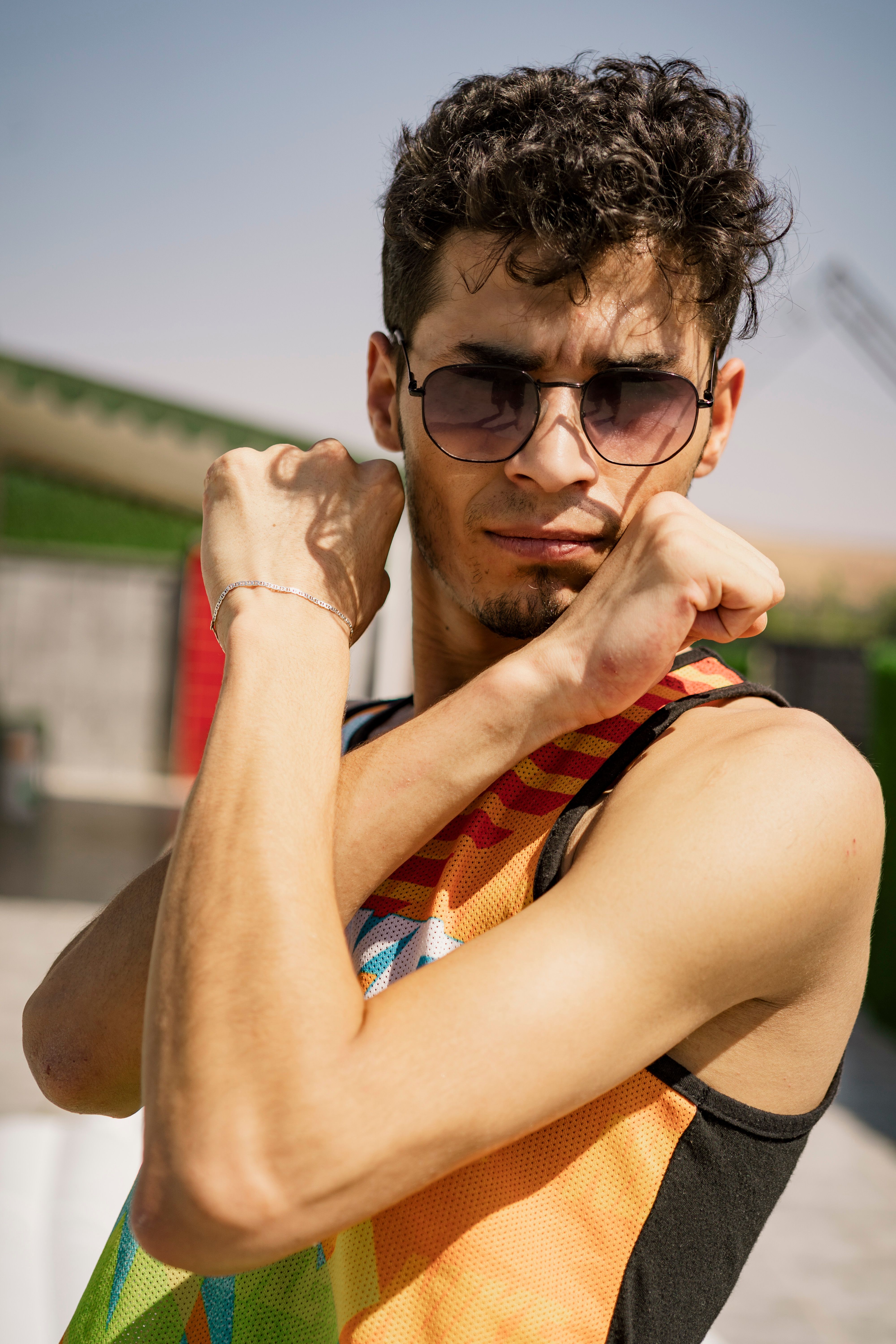 Stylish young man striking a pose with arms crossed outdoors in Gaziantep.