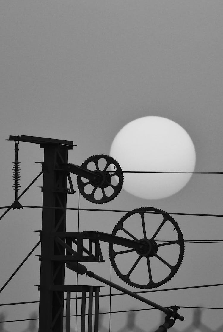 Gears And Full Moon Behind