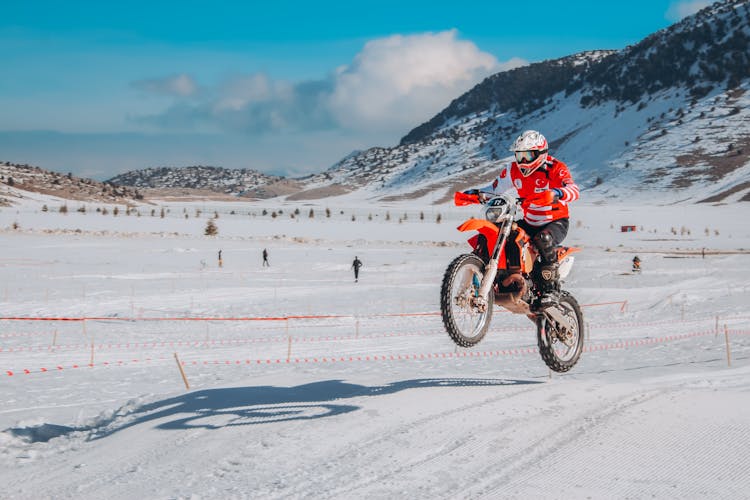 A Person Riding A Motorcycle On Winter