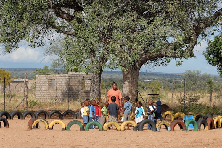 Woman With The Kids In A Playground