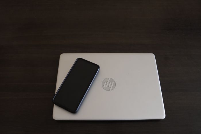 Laptop and smartphone on desk — laptop dealer Harsha Electronics Mankhurd West Mumbai