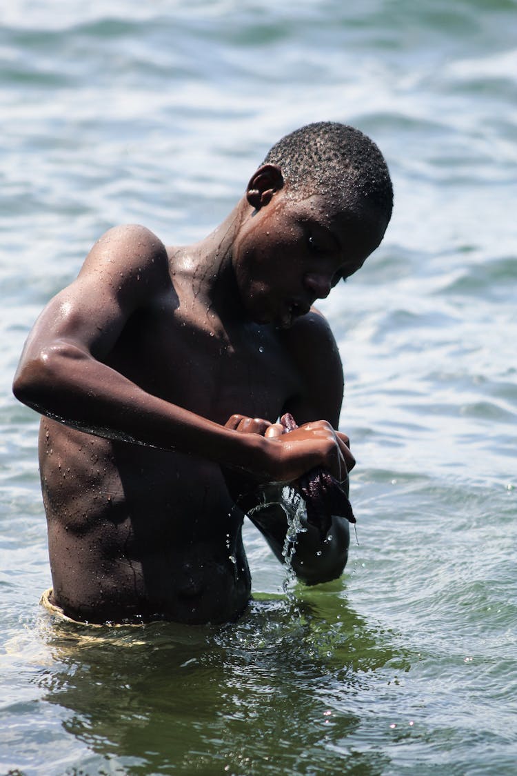 Man In The Water Holding A Cloth