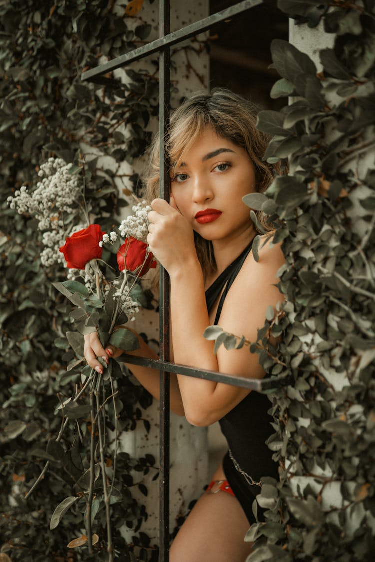 Woman Wearing Black Dress And Red Garter Belt Holding Bouquet