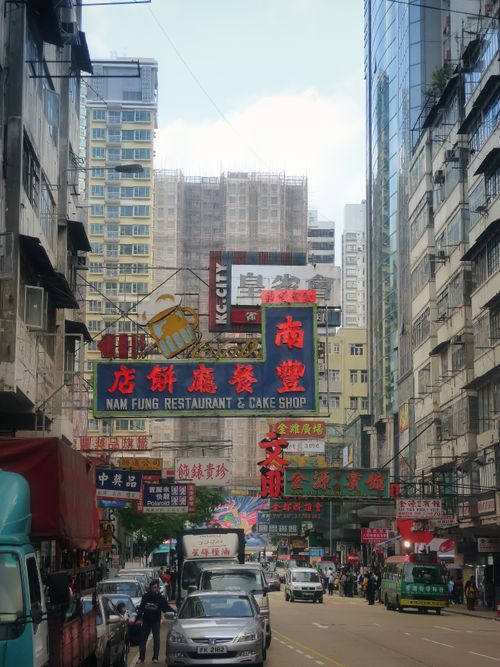Free Vibrant urban scene in Kowloon, Hong Kong with colorful signage and busy street life. Stock Photo