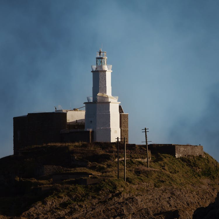 White Lighthouse On Top Of Cliff