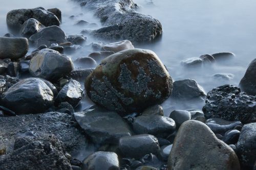 Free A serene view of rocky seashore at The Mumbles, Wales, United Kingdom. Stock Photo
