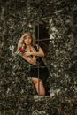 Woman Wearing Black Dress and Red Garter Belt Holding Bouquet