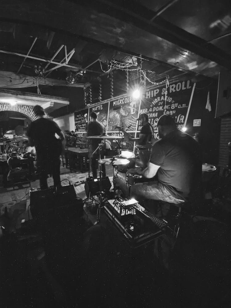 Grayscale Photo Of A Band Playing In A Bar