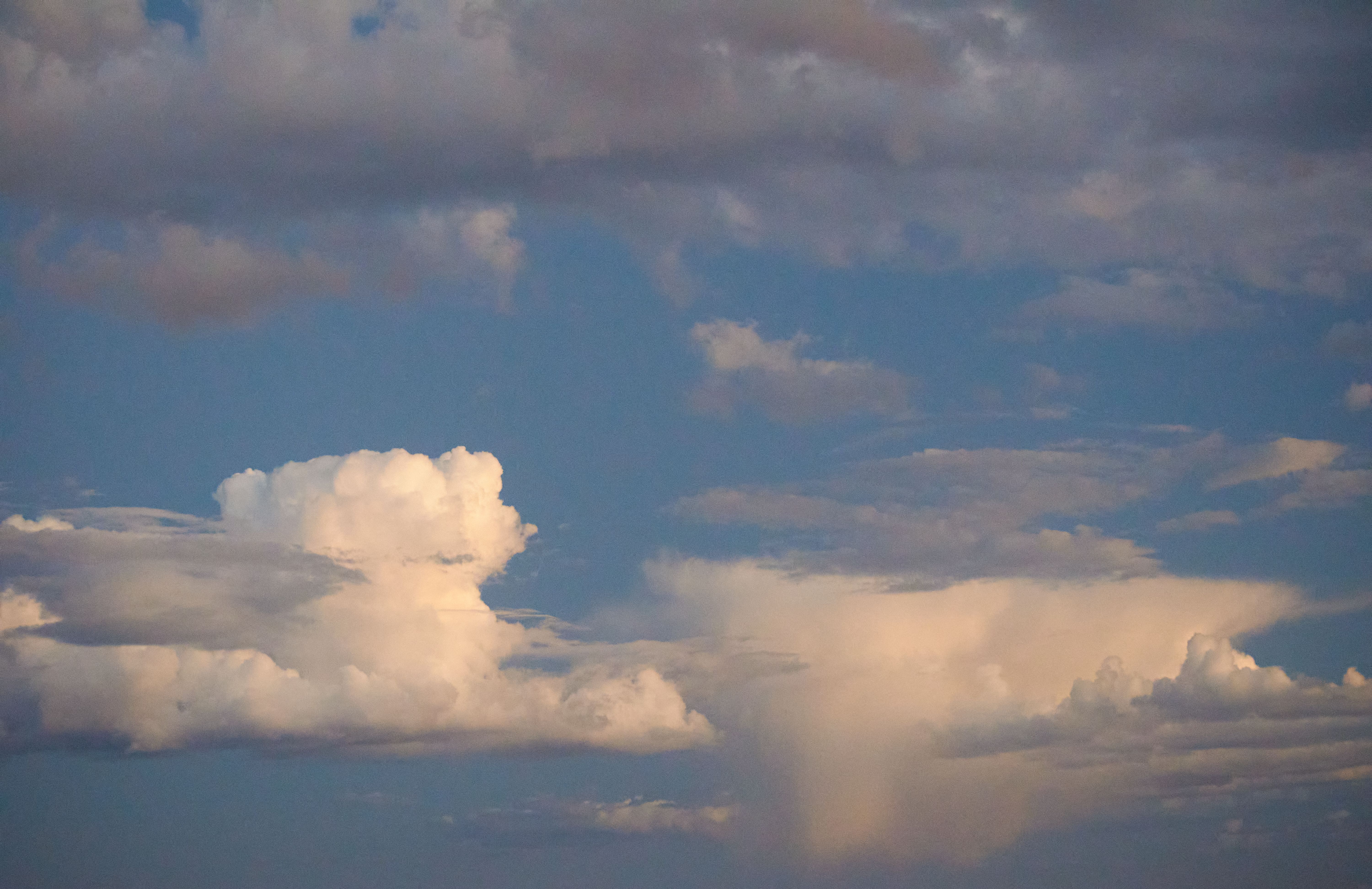 A serene view of fluffy cumulus clouds under a bright blue sky, perfect for backgrounds.