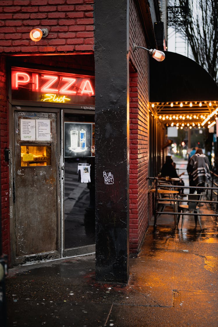 Photo Of A Pizza Shop With A Neon Signage