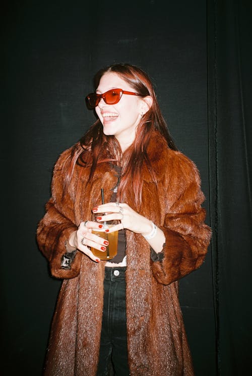 Free Woman in Fur Coat with a Drink in her Hand Stock Photo