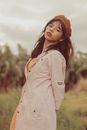 Woman in White Long Sleeve Shirt Standing on Green Grass Field