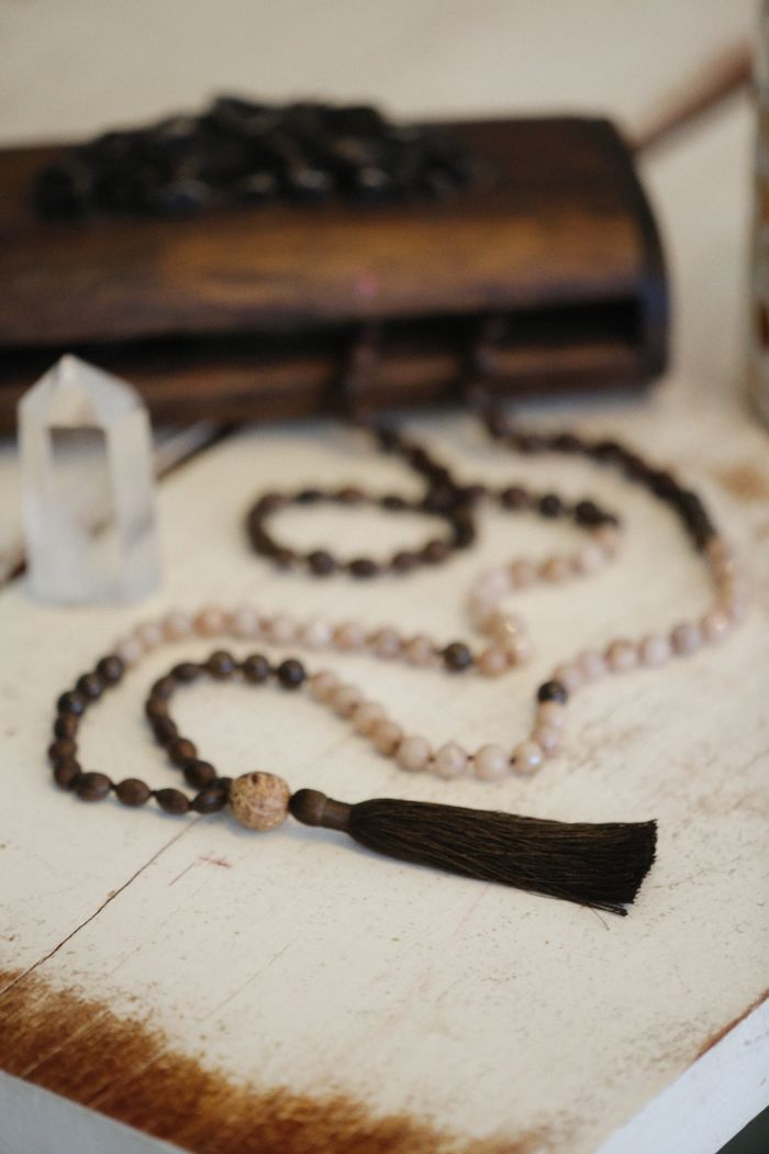 A crystal japa mala laid on white